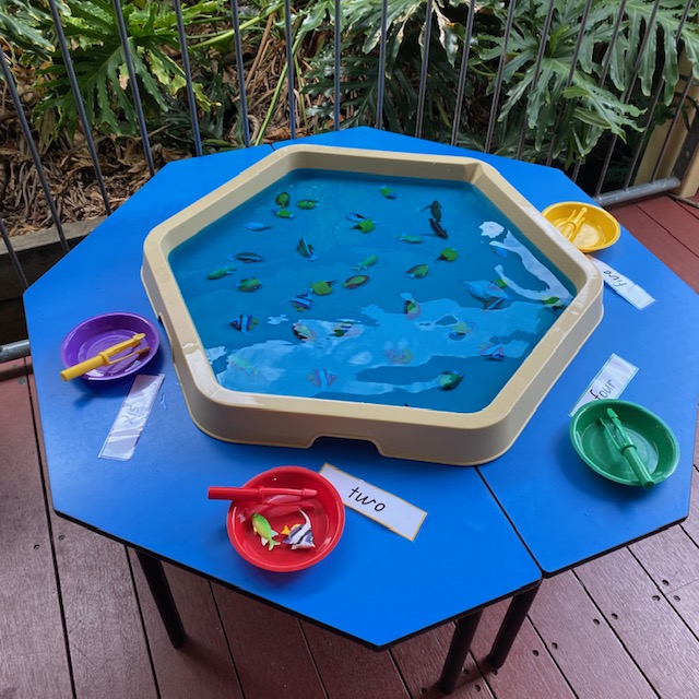 Number fishing Hex Tray activity featuring plastic numbered fish in water