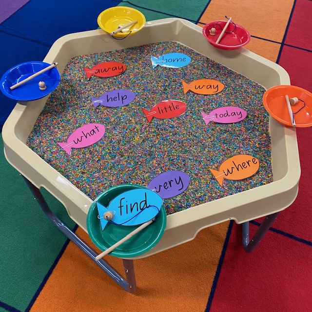Sight words Hex Tray activity featuring fishing rods and cardboard sight word fish and coloured rice 