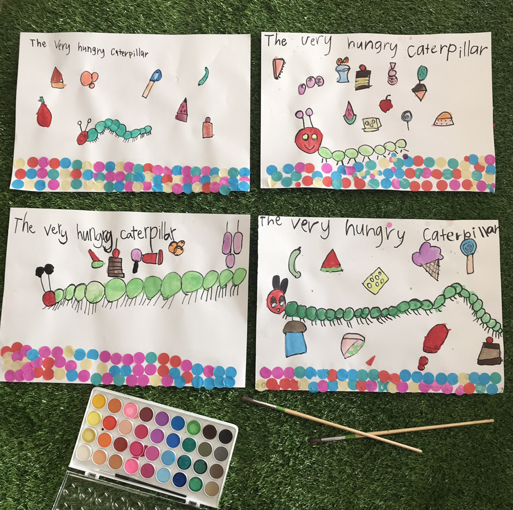 Children used The Very Hungry Caterpillar book written by Eric Carle as inspiration for a painting of their very own hungry caterpillar