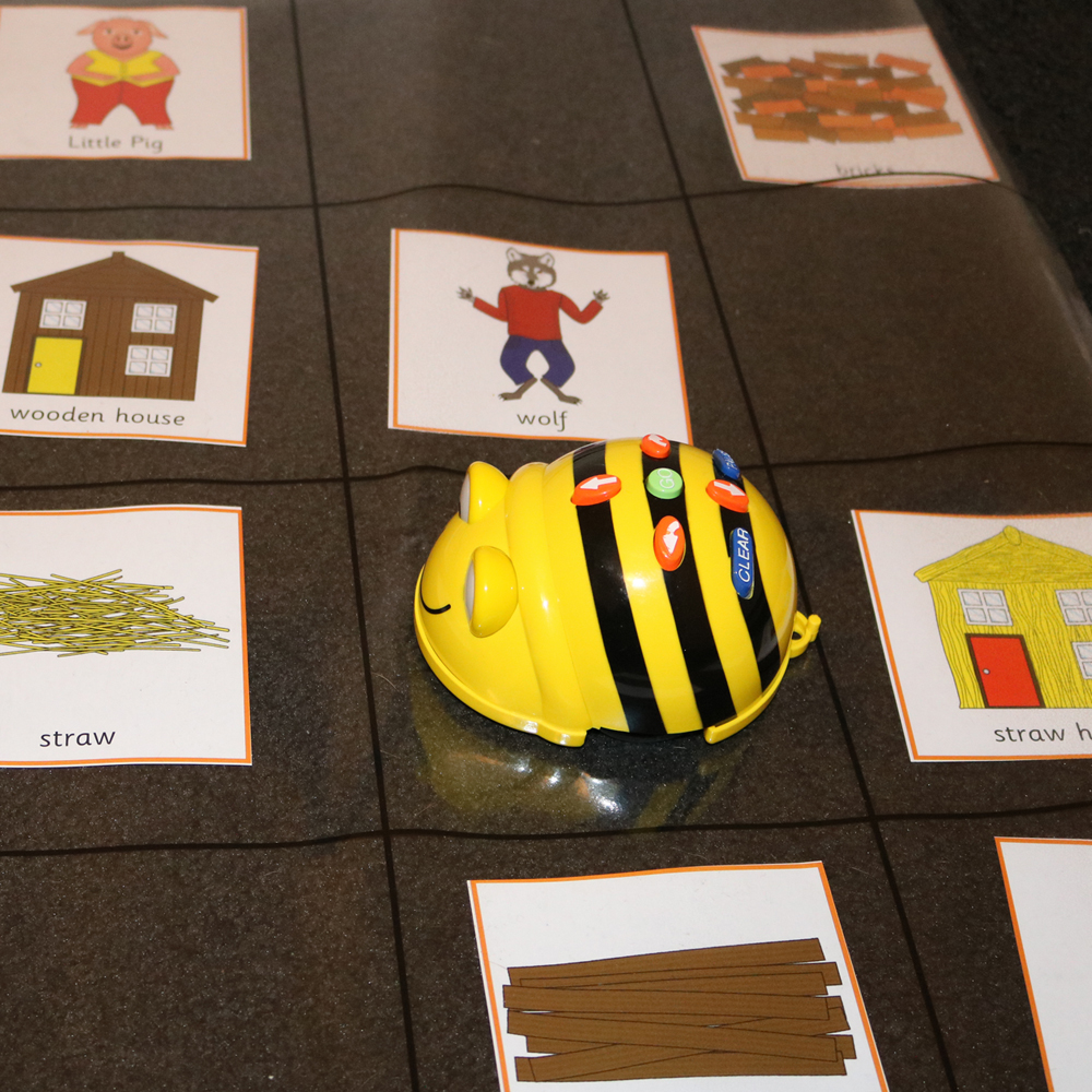 Retelling stories with Beebot and three little pig images on map 