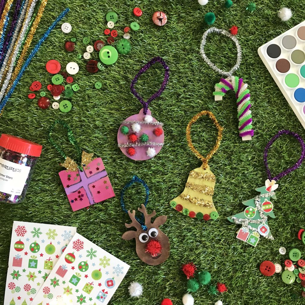 assorted christmas decorations activities and stickers on grass background