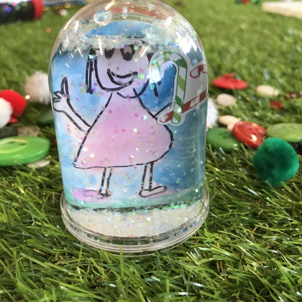Homemade snow globe with portrait drawing inside