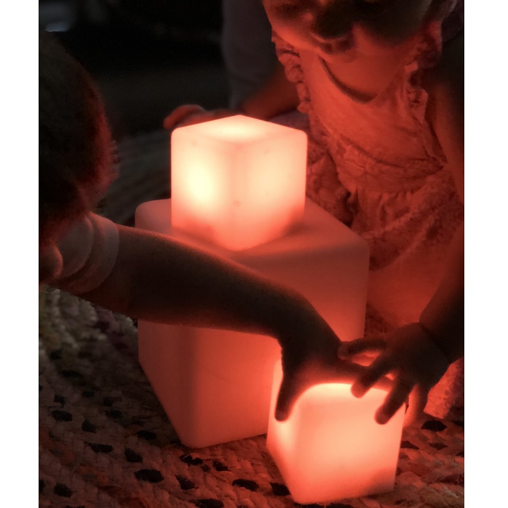 Two children playing with sensory light blocks