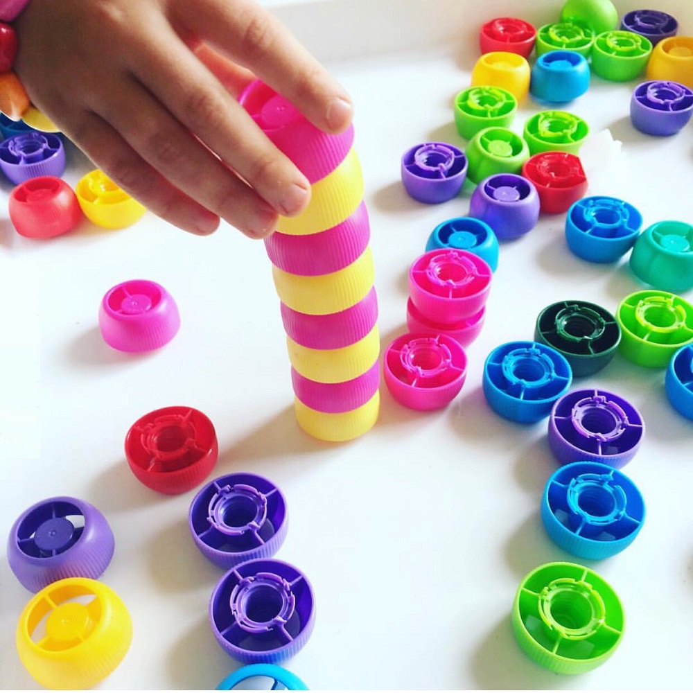 Child stacking colourful counters