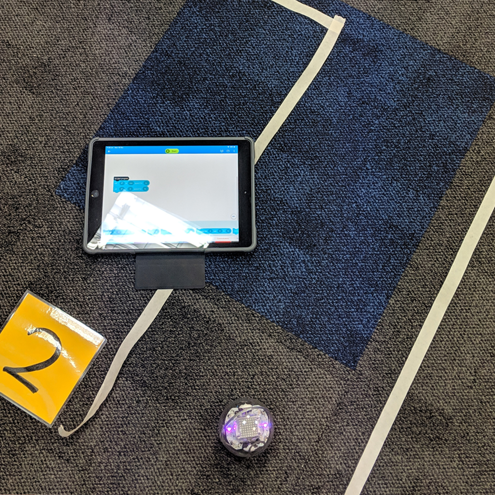 Sphero iPad activity on floor with a route made from tape