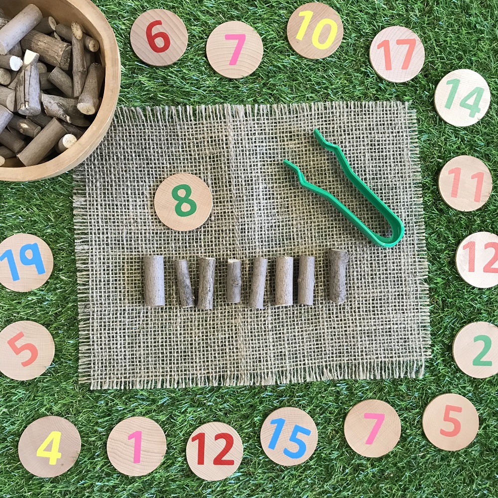 Numbers written on branch cuts with 8 twigs placed next to the number 8 on a branch cut
