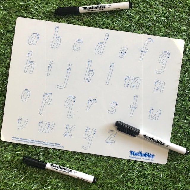 alphabet whiteboard and pen on grass background