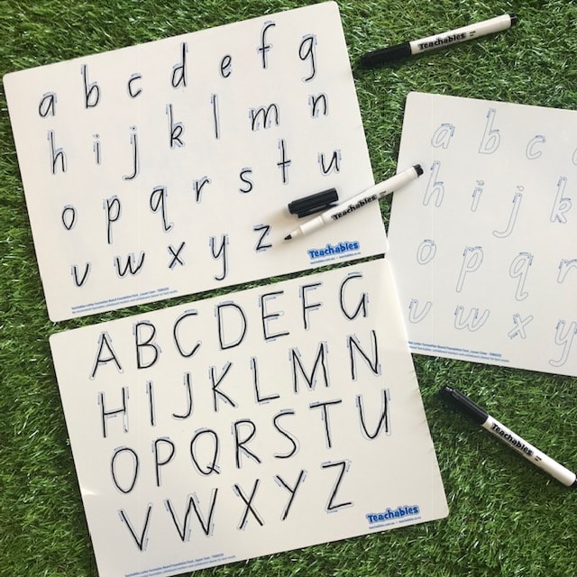 alphabet whiteboards completed on grass background