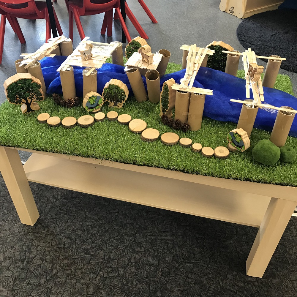 recreation of the story three billy goats gruff made from toilet roll, wooden sticks and false grass