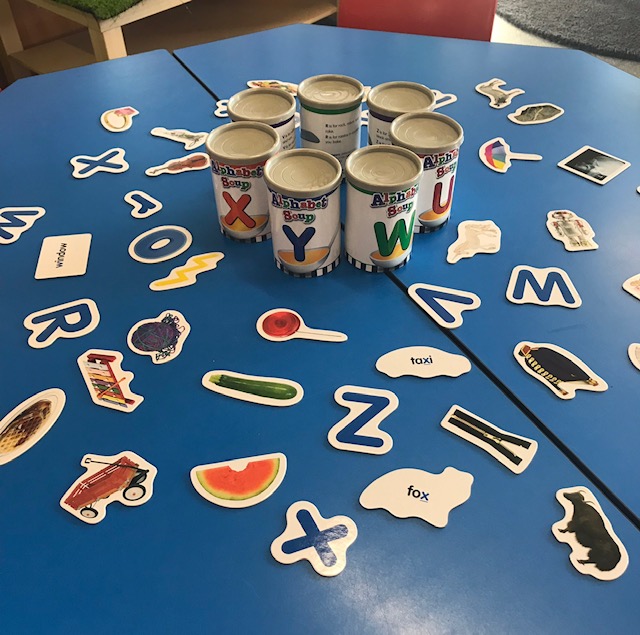 Alphabet soup sorter cans activity on classroom desk
