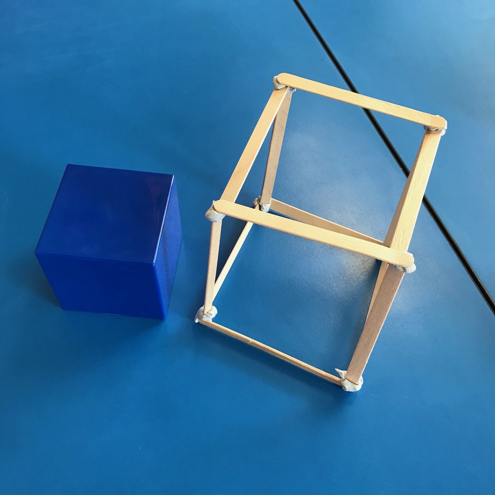 Cube prism shape made of paddle pop sticks stuck together with blu tack