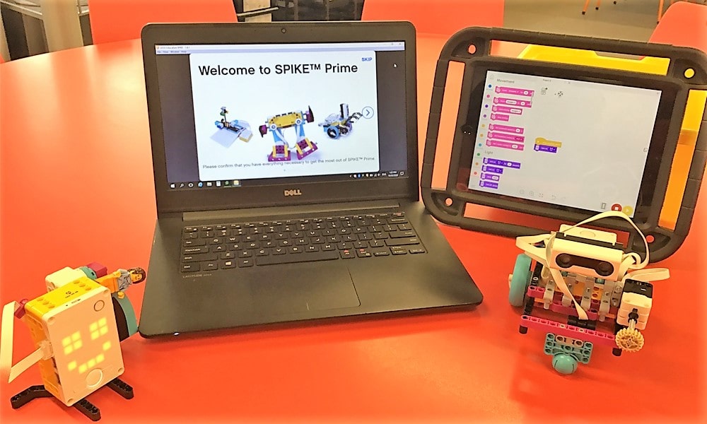 lego spike on laptop and tablet with models on class desk