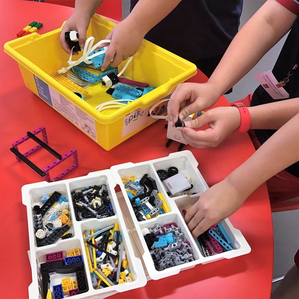 lego spike trays with kids hands