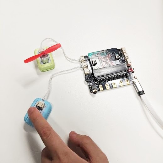 microbit fan sensor with button and childs hand