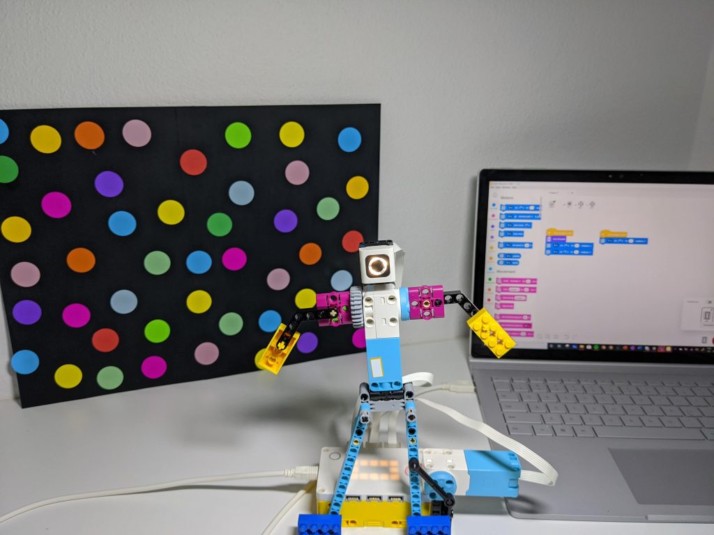 LEGO Spike Dancing Robot with laptop showing Coding blocks in background