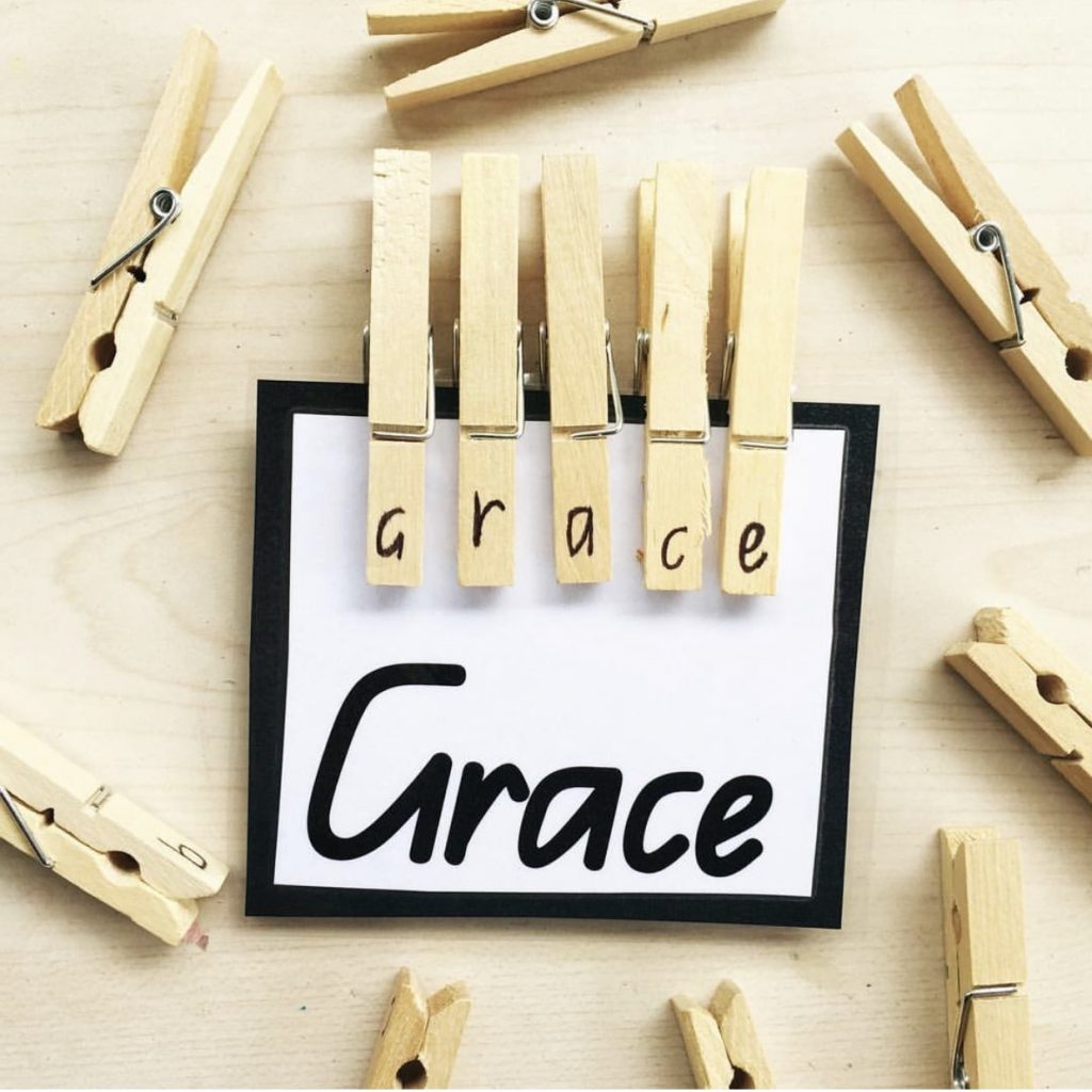 Peg name activity featuring pegs with letters on clipped to card with name spelt out