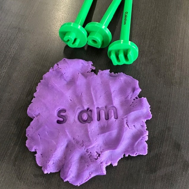 Playdough stamping, purple playdough and green alphabet stamps