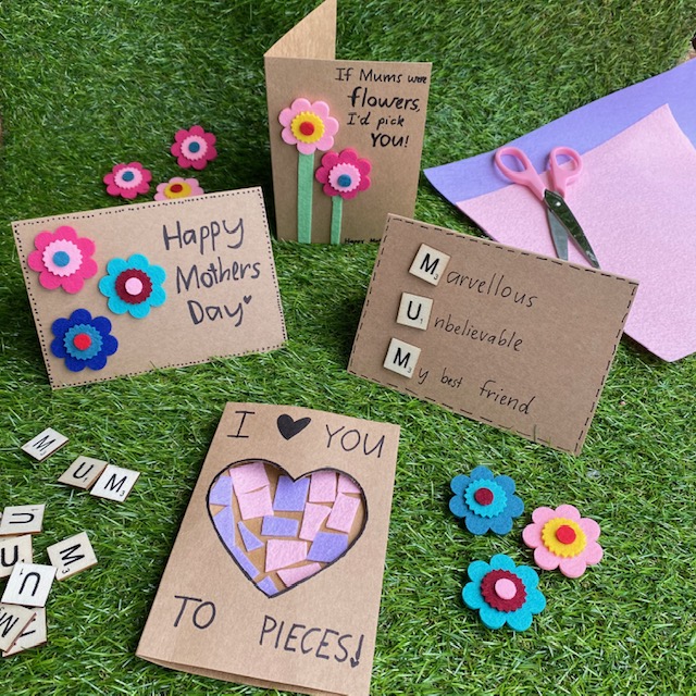 Handmade cards craft activity on grass background