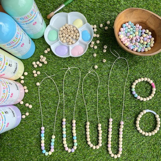 Wooden bead Necklaces craft activity on grass background