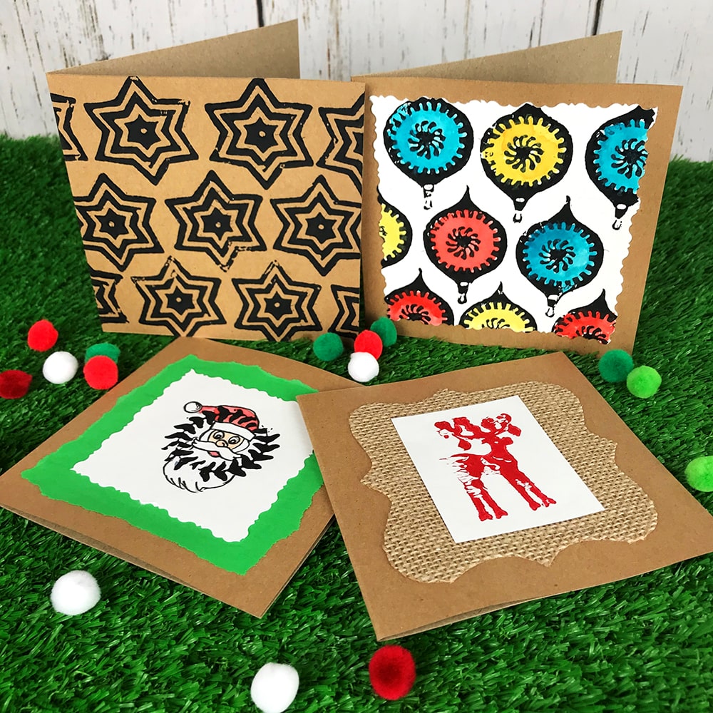 Christmas Craft Cards and pom poms on grass background