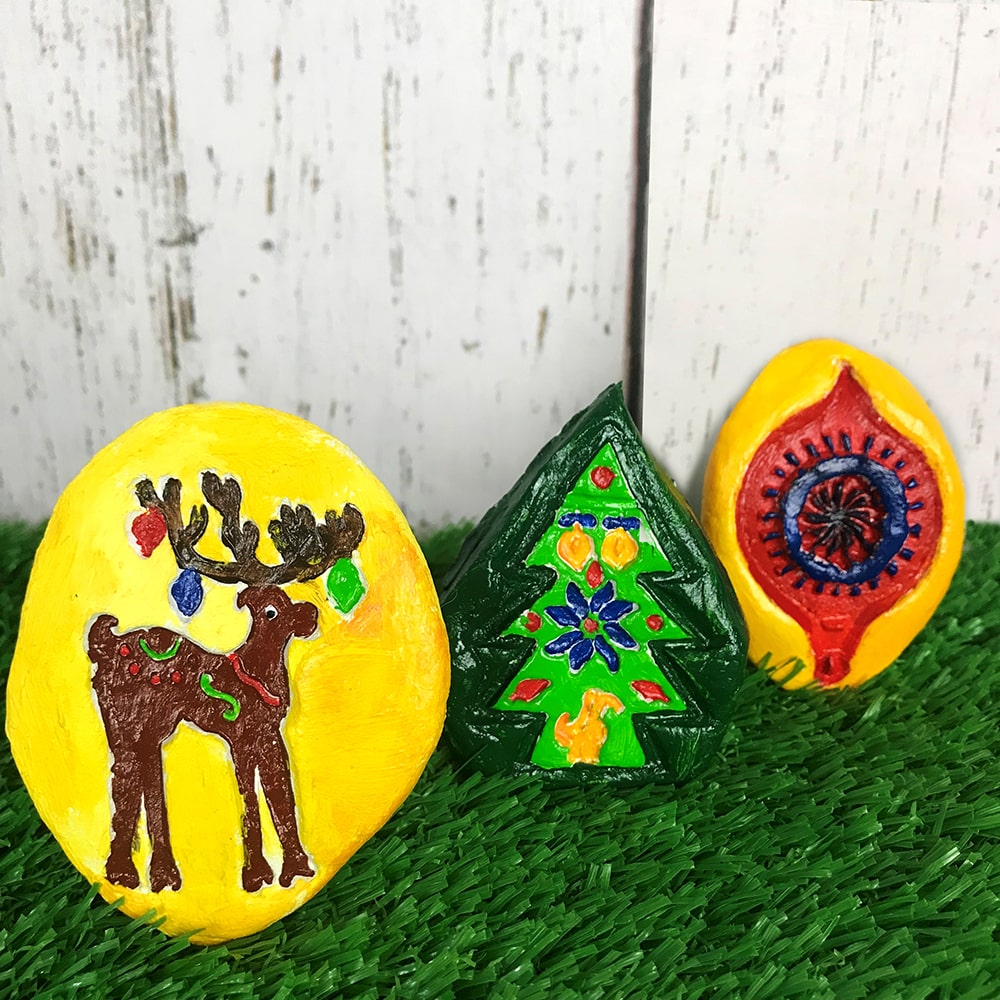 Christmas craft brooches on grass background