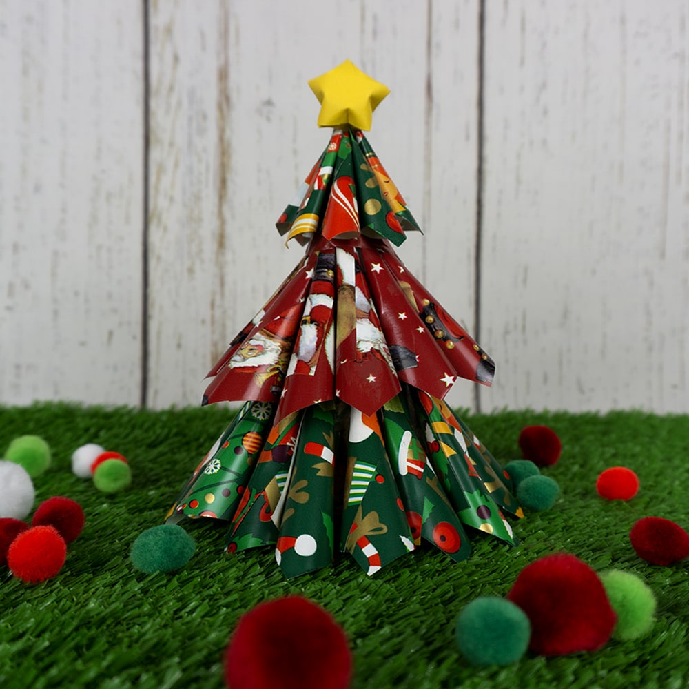 Christmas Tree and pom poms on grass background