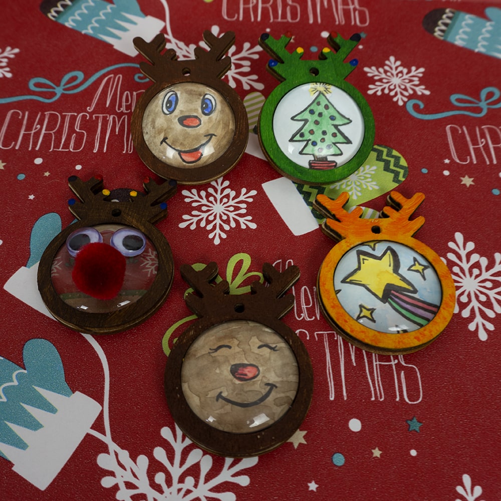 Christmas craft ornaments sitting on Christmas paper