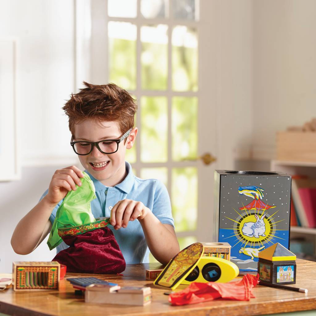 Child playing with Magic set at home