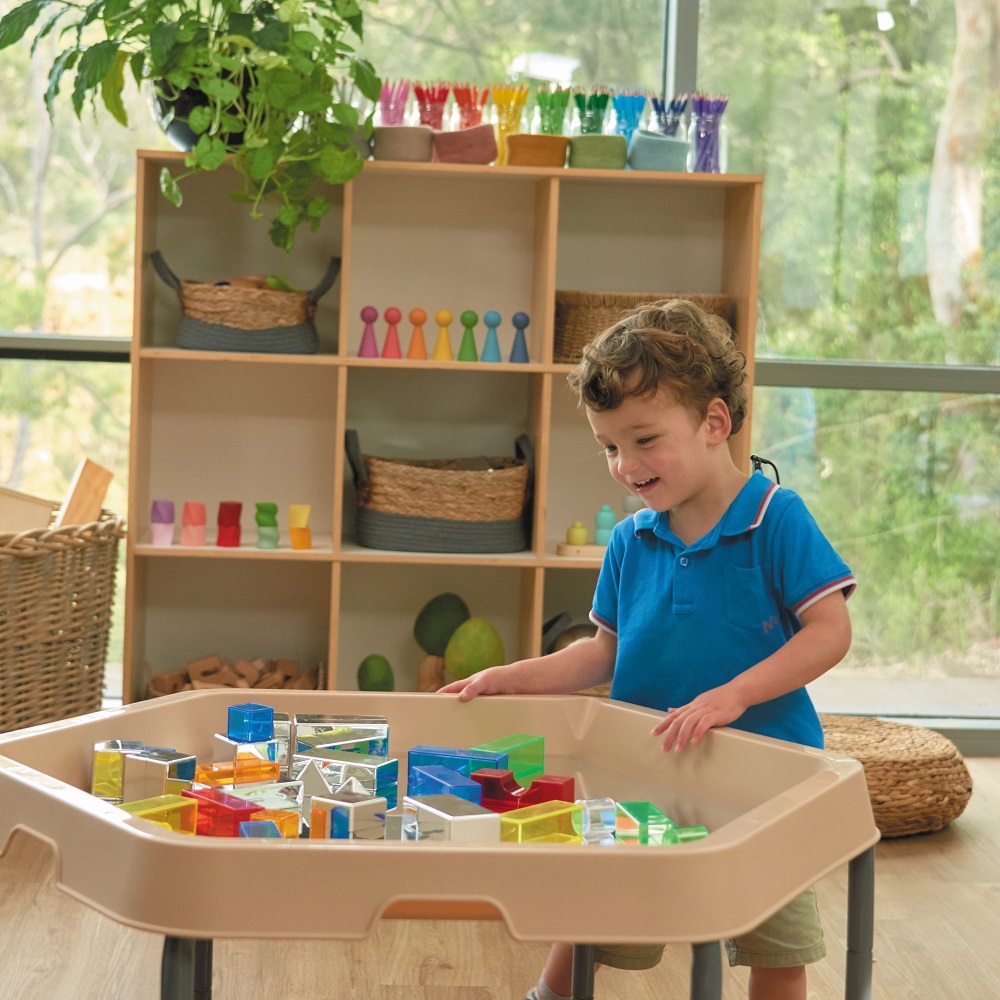 child playing with Hex tray in classroom