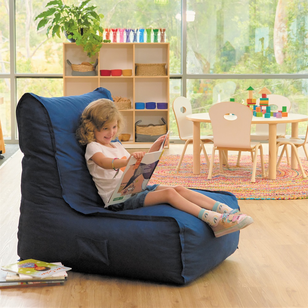 Young girl sat on beanbag chair in childcare learning environment