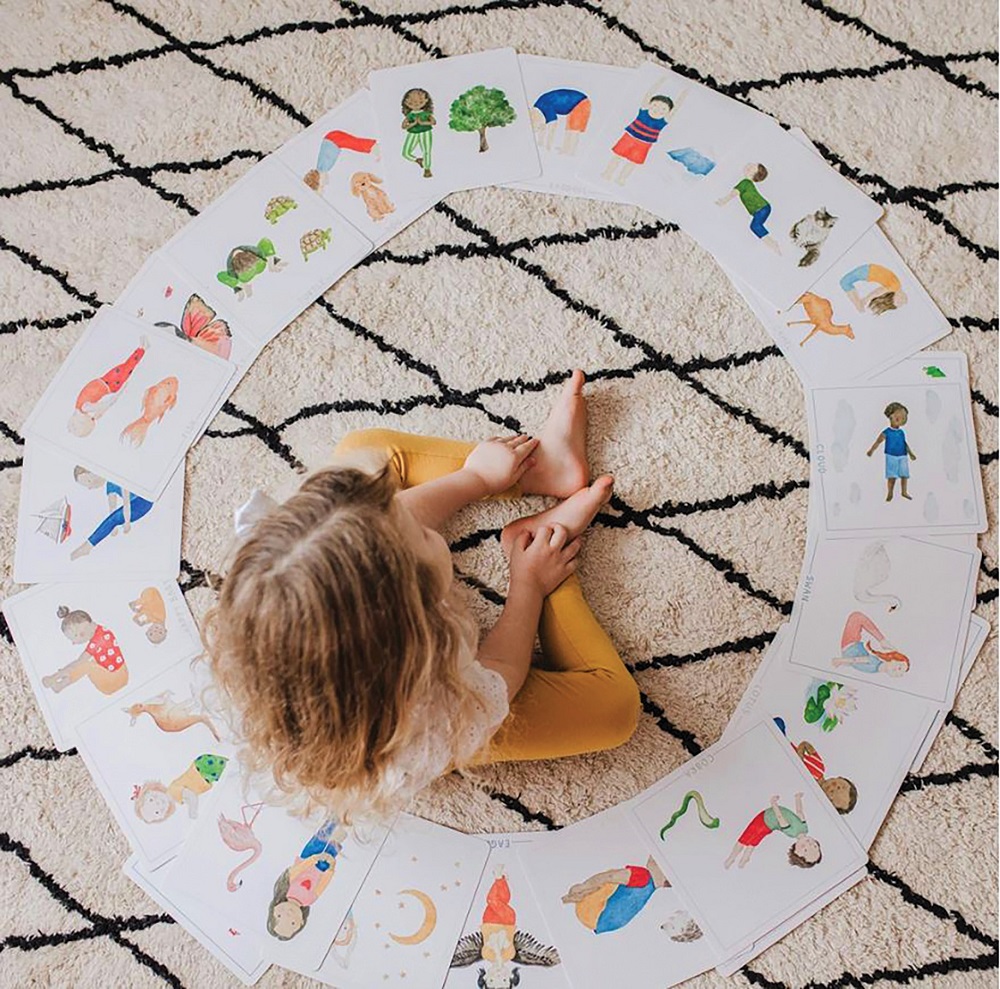 Birds eye view of young girl surrounded by mindful picture cards