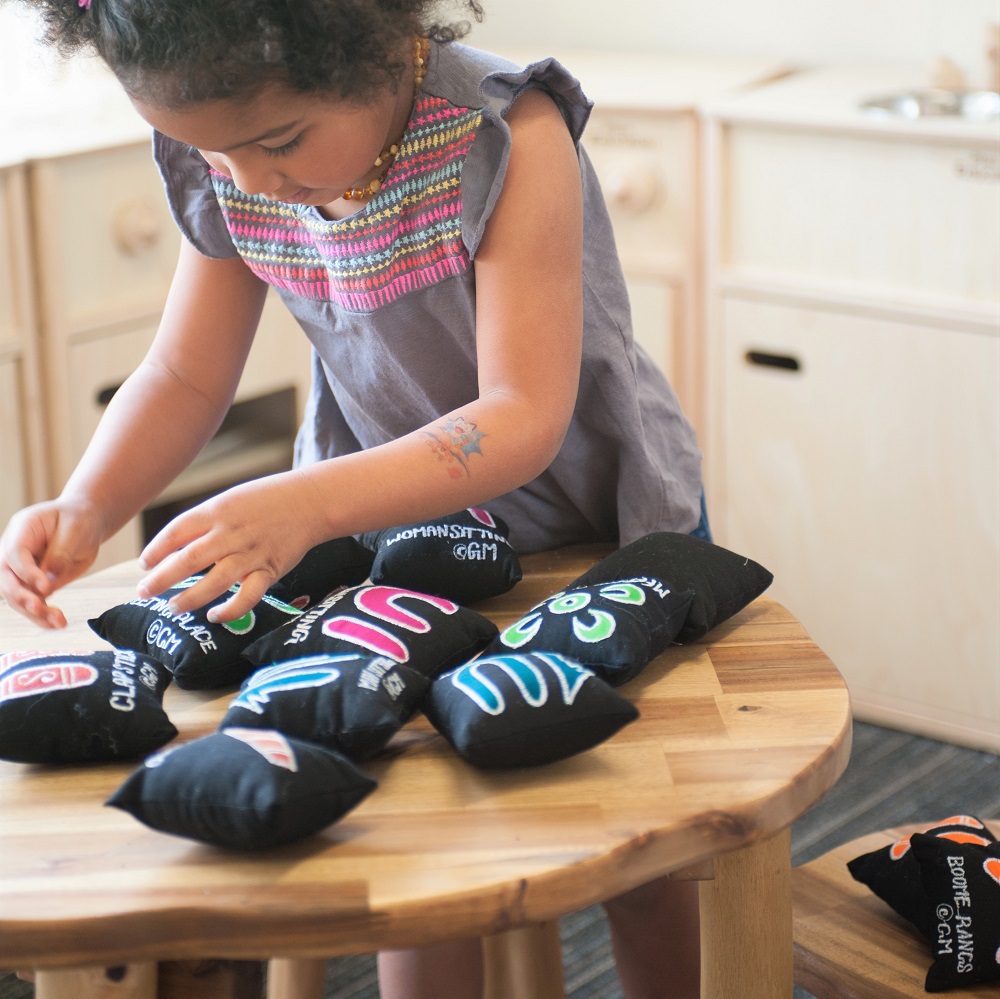 Young girl playing with culturally meaningful resources on table