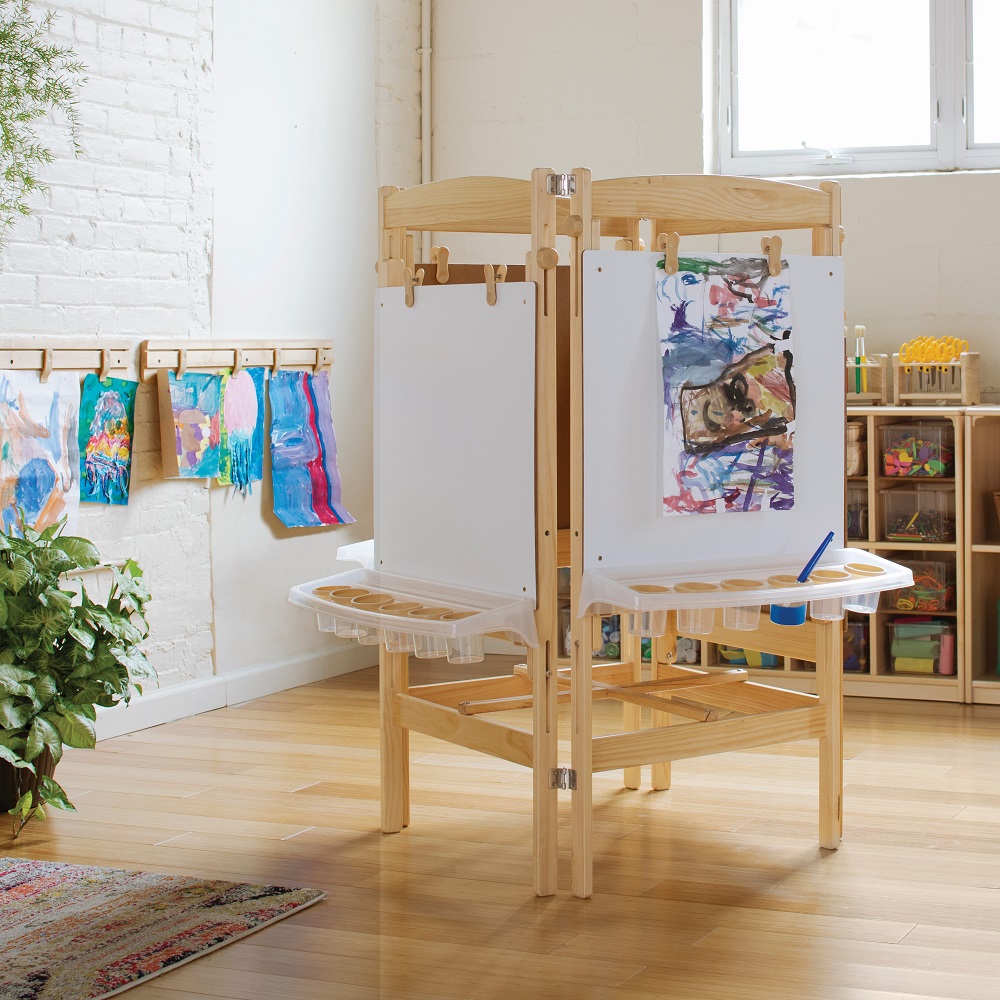 Paining easel with paintings hanging in childcare learning environment