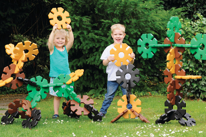 Children playing with construction game in garden