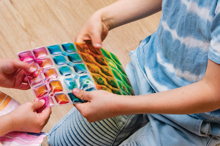 Child holding sensory squares