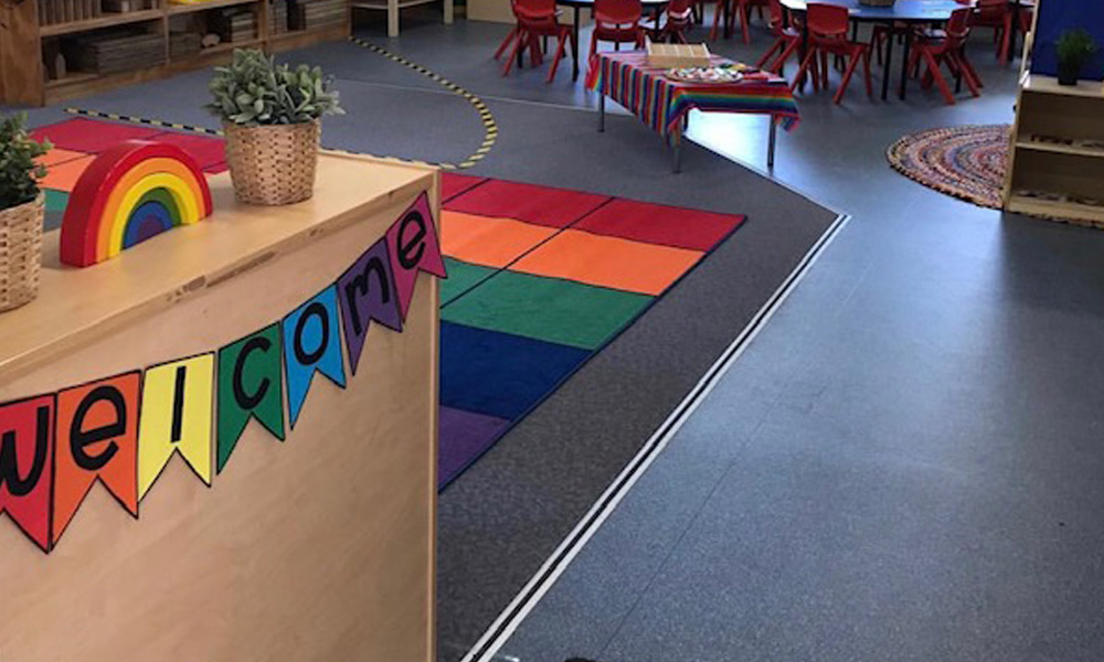 primary school classroom with welcome banner and colourful rug