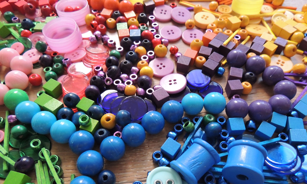 Coloured Loose Parts On Desk Buttons Beads Counters And Matchsticks